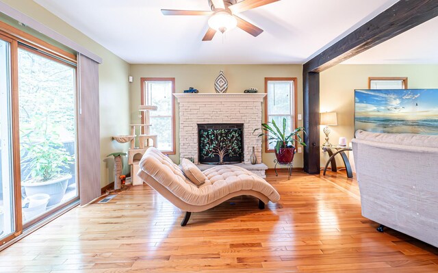 1154 Park Dr, East Stroudsburg, PA 18302 - living room featuring a ceiling fan, light wood finished floors, and a fireplace