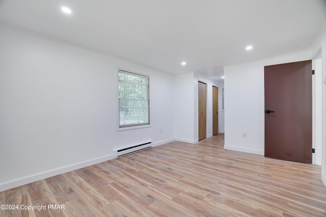 spare room featuring baseboards, recessed lighting, a baseboard radiator, and light wood-style floors