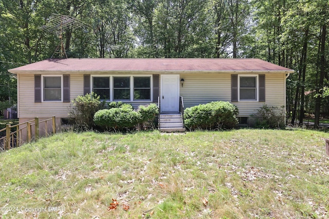 view of front of home with a front yard, fence, and entry steps