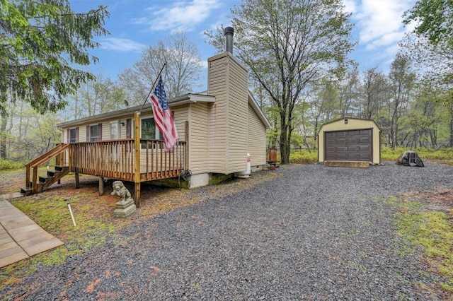 605 Scenic Dr, Albrightsville, PA 18210 - view of home's exterior with a deck, an outbuilding, a chimney, gravel driveway, and a garage