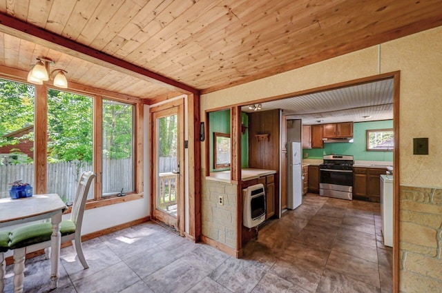 209 Cross St, Pocono Lake, PA 18347 - kitchen featuring stainless steel stove, heating unit, wooden ceiling, freestanding refrigerator, and light countertops