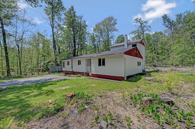 209 Cross St, Pocono Lake, PA 18347 - view of front facade with a chimney and a front yard