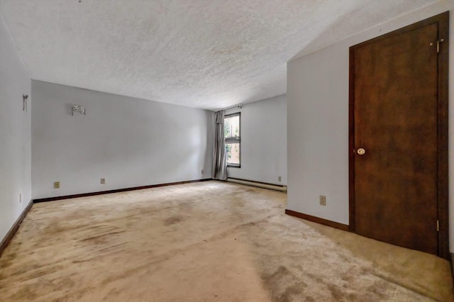 209 Cross St, Pocono Lake, PA 18347 - spare room featuring a textured ceiling, a baseboard radiator, and baseboards