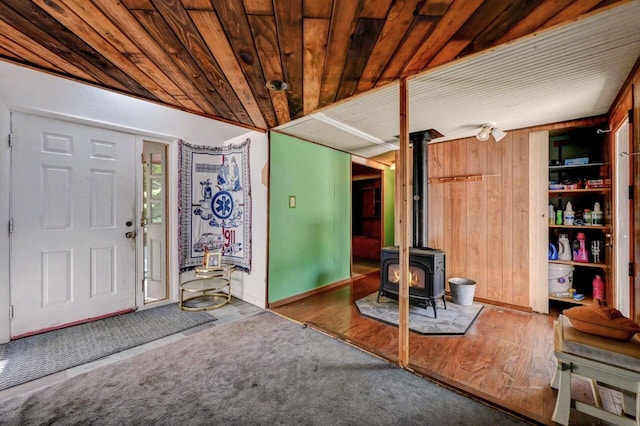 209 Cross St, Pocono Lake, PA 18347 - entrance foyer with a wood stove, wood ceiling, wood walls, wood finished floors, and baseboards