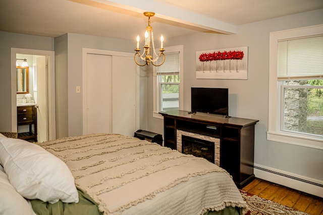 2735 Rte 390, Canadensis, PA 18325 - bedroom featuring a baseboard heating unit, wood finished floors, a chandelier, multiple windows, and beam ceiling