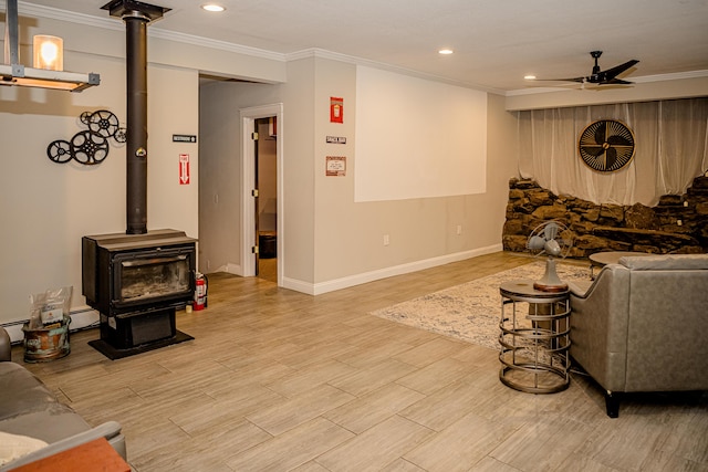 2735 Rte 390, Canadensis, PA 18325 - living room with ceiling fan, a wood stove, crown molding, recessed lighting, and baseboards