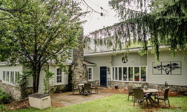 2735 Rte 390, Canadensis, PA 18325 - rear view of property with a patio area, a yard, outdoor dining space, and stone siding