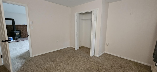 8934 Deerfield Rd, Tobyhanna, PA 18466 - unfurnished bedroom featuring carpet flooring and a wood stove