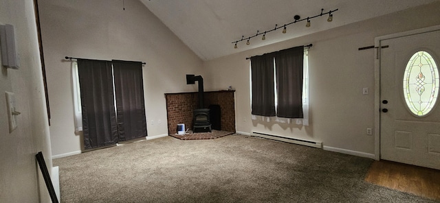 8934 Deerfield Rd, Tobyhanna, PA 18466 - carpeted foyer entrance with a wood stove, a baseboard heating unit, and high vaulted ceiling