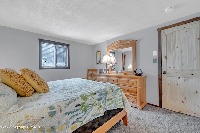 bedroom with light carpet, baseboards, and a textured ceiling