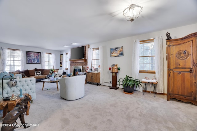 living area featuring carpet floors, a fireplace, and baseboards