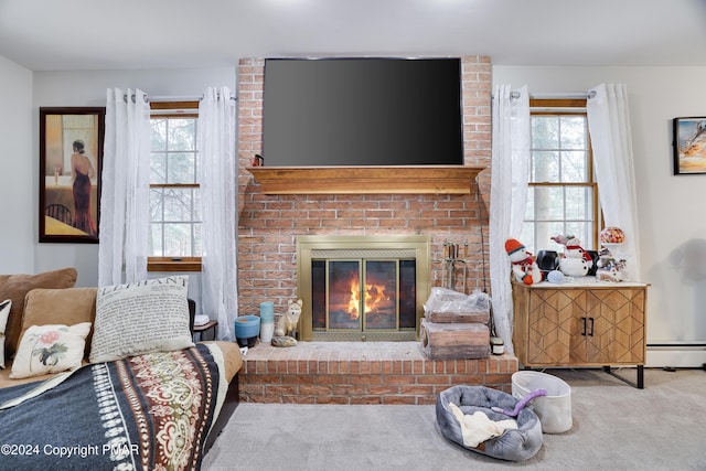 carpeted living area with a baseboard radiator, a brick fireplace, and a healthy amount of sunlight