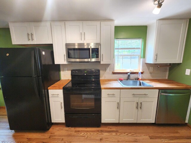 9 Theocritus Cir, Albrightsville, PA 18210 - kitchen featuring black appliances, wood counters, white cabinets, and light wood-style flooring