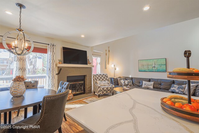 living room with light wood-type flooring and an inviting chandelier