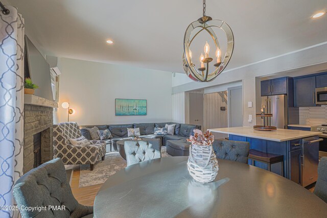 dining space featuring hardwood / wood-style floors and an inviting chandelier