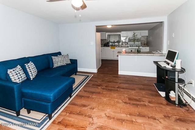 living room with dark wood-type flooring and ceiling fan