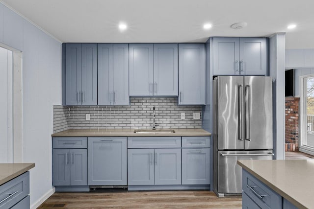 2094 Scarborough Way, Bushkill, PA 18324 - kitchen with high end fridge, light wood-style floors, light countertops, tasteful backsplash, and a sink