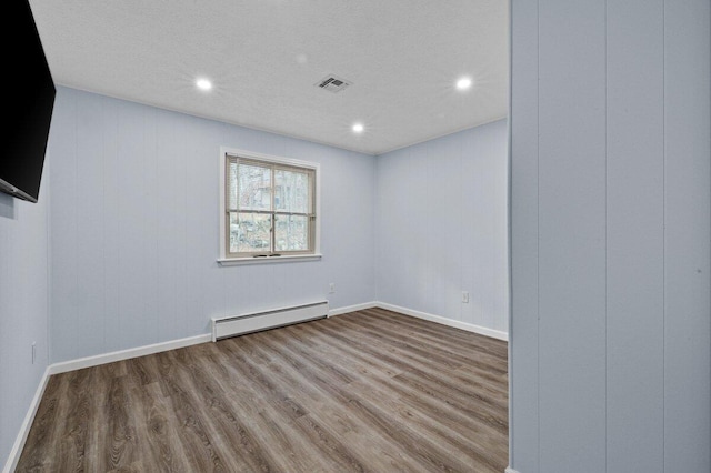 2094 Scarborough Way, Bushkill, PA 18324 - spare room featuring visible vents, recessed lighting, a baseboard heating unit, and wood finished floors