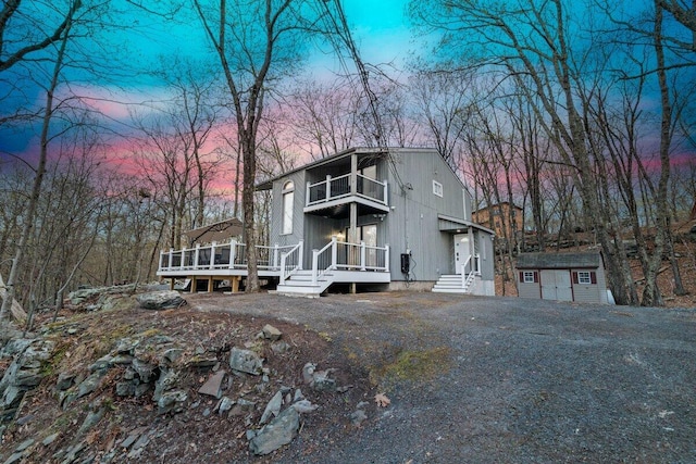 2094 Scarborough Way, Bushkill, PA 18324 - view of front of house with a wooden deck, an outbuilding, a balcony, and a shed