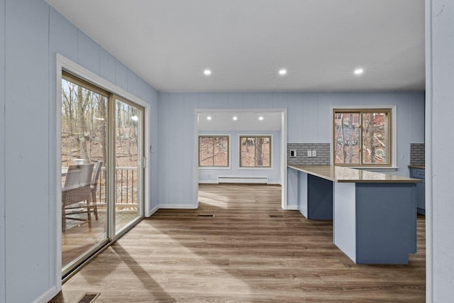 2094 Scarborough Way, Bushkill, PA 18324 - interior space featuring visible vents, a peninsula, wood finished floors, recessed lighting, and a baseboard radiator