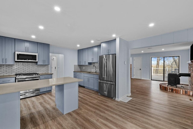 2094 Scarborough Way, Bushkill, PA 18324 - kitchen featuring a sink, a wood stove, stainless steel appliances, recessed lighting, and tasteful backsplash