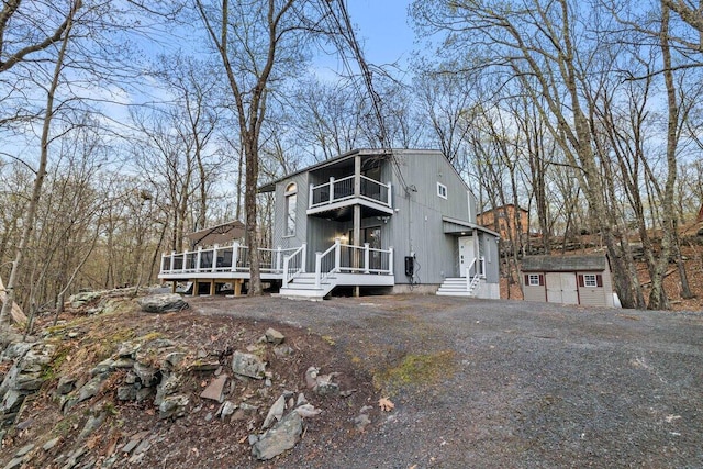 2094 Scarborough Way, Bushkill, PA 18324 - view of front facade featuring a storage unit, an outbuilding, a balcony, and a deck