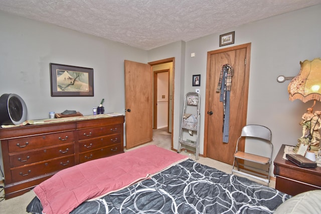 carpeted bedroom featuring a textured ceiling