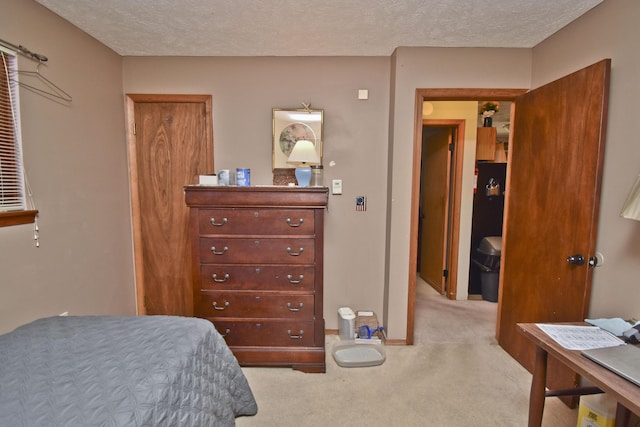 bedroom with baseboards, carpet, and a textured ceiling