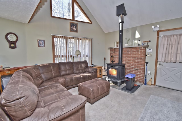 living area featuring high vaulted ceiling, a wood stove, and carpet