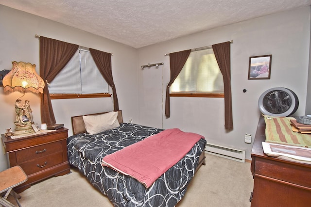 bedroom featuring carpet flooring, a textured ceiling, and a baseboard radiator