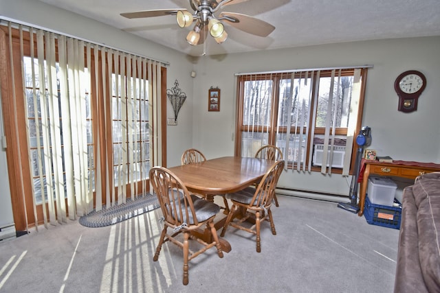 dining room with a baseboard heating unit, cooling unit, carpet, and ceiling fan