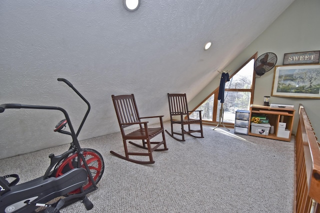 living area featuring carpet flooring, a textured ceiling, and lofted ceiling