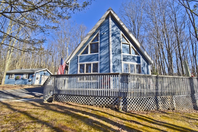 rear view of house with a yard and a deck