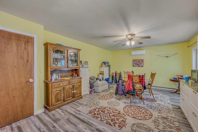 6163 Somers Ter, Tobyhanna, PA 18466 - dining space with a wall mounted AC, light wood finished floors, and a ceiling fan