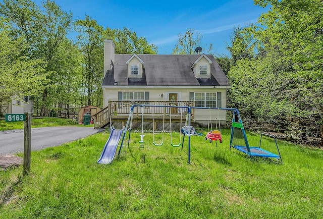 6163 Somers Ter, Tobyhanna, PA 18466 - view of front of property featuring a playground, a front yard, a wooden deck, an outbuilding, and a chimney
