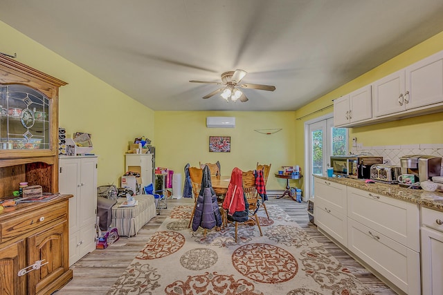 6163 Somers Ter, Tobyhanna, PA 18466 - dining space featuring light wood-style flooring, ceiling fan, and a wall mounted air conditioner