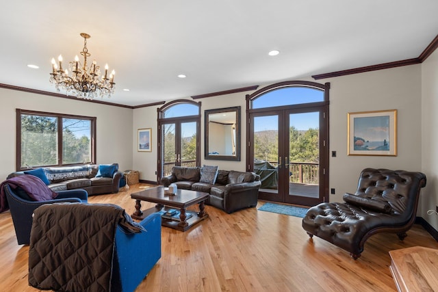 living area featuring french doors, crown molding, recessed lighting, light wood-style flooring, and baseboards