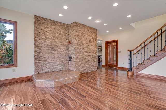 entryway featuring stairs, recessed lighting, baseboards, and wood finished floors