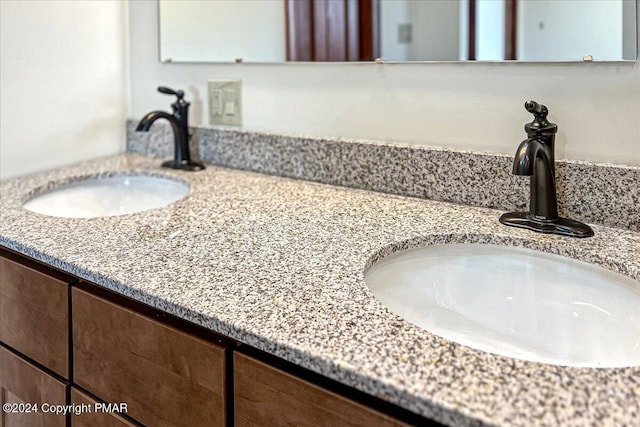 bathroom with a sink and double vanity