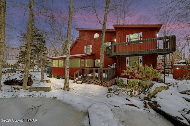 snow covered house with a deck