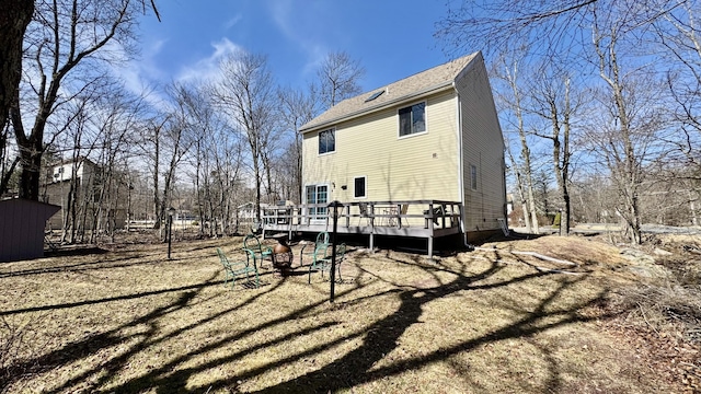 rear view of property featuring a wooden deck