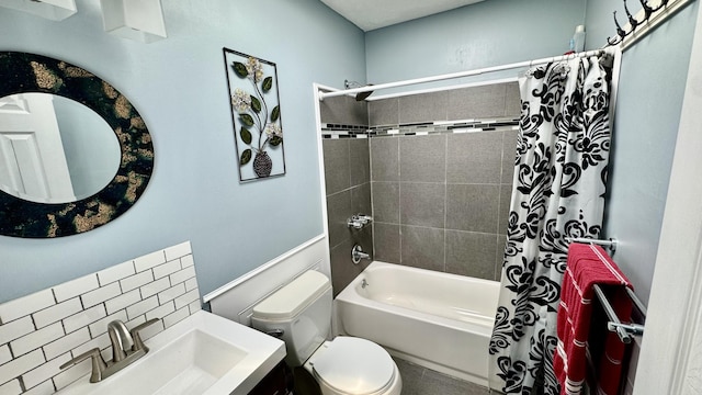 full bath featuring toilet, a sink, and shower / tub combo