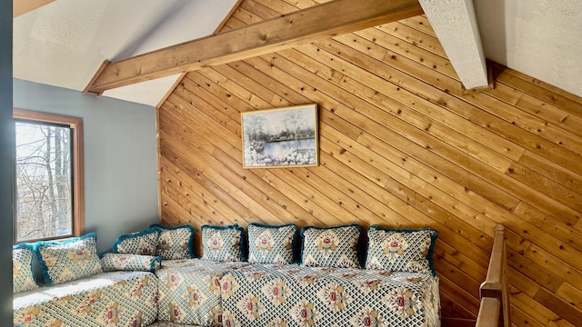 bedroom with lofted ceiling with beams and wood walls
