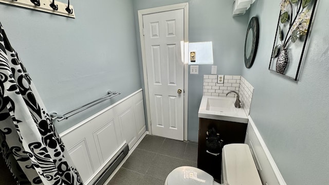 bathroom featuring toilet, tasteful backsplash, tile patterned flooring, and vanity