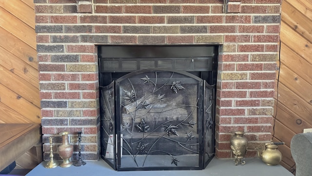 details featuring a brick fireplace and finished concrete floors