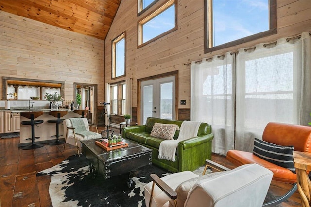 living area with wood walls, lofted ceiling, wooden ceiling, and dark wood finished floors