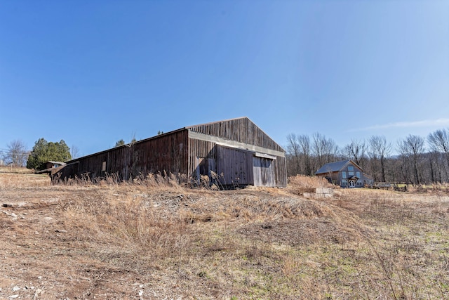 view of home's exterior with a pole building, an outdoor structure, and a garage