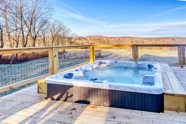 deck featuring an outdoor hot tub