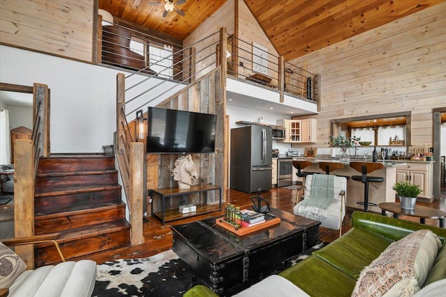 living room with dark wood-type flooring, wooden walls, and wood ceiling