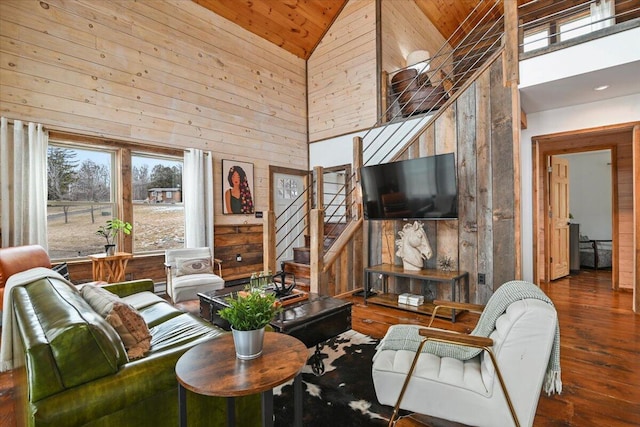 living room with high vaulted ceiling, wooden walls, hardwood / wood-style flooring, and wooden ceiling